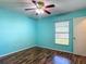 Bedroom with laminate floors, ceiling fan, and a window with blinds at 1517 Gunsmith Dr, Lutz, FL 33559