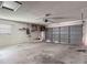Spacious garage with a gray door, concrete floor, and ample storage space at 1517 Gunsmith Dr, Lutz, FL 33559