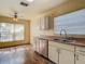 Cozy kitchen with white cabinets, stainless steel appliances, and a window over the sink at 1517 Gunsmith Dr, Lutz, FL 33559