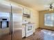 Kitchen showcasing stainless steel refrigerator, white cabinets, and laminate countertops at 1517 Gunsmith Dr, Lutz, FL 33559