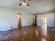 View of open living room with ceiling fan and easy access to other rooms in the house at 1517 Gunsmith Dr, Lutz, FL 33559