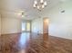 Large open concept living room featuring wood flooring and easy access to the backyard at 1517 Gunsmith Dr, Lutz, FL 33559