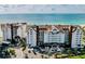 Aerial view of a beachfront condo complex with meticulously maintained landscaping and ample parking, offering a luxurious coastal lifestyle at 1586 Gulf Blvd # 2502, Clearwater, FL 33767