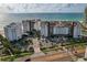 Stunning aerial view of beachfront condos, lush landscaping, and ocean views at 1586 Gulf Blvd # 2502, Clearwater, FL 33767