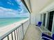 A balcony overlooking the ocean, featuring comfortable seating and access to breathtaking seaside views at 1586 Gulf Blvd # 2502, Clearwater, FL 33767