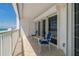 Balcony featuring sliding glass doors with two chairs and a small table at 1586 Gulf Blvd # 2502, Clearwater, FL 33767