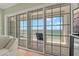 Sliding glass doors lead to a balcony with chairs and views of the ocean at 1586 Gulf Blvd # 2502, Clearwater, FL 33767