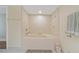 Large soaking tub in bathroom with tile surround and tiled floors at 1586 Gulf Blvd # 2502, Clearwater, FL 33767