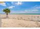 Beach access featuring a white picket fence, providing a pathway to the sand and sea at 1586 Gulf Blvd # 2502, Clearwater, FL 33767