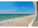 Expansive beach view with light turquoise ocean water under a blue sky and wispy clouds at 1586 Gulf Blvd # 2502, Clearwater, FL 33767