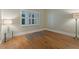 Empty bedroom featuring hardwood floors and a window with white shutters at 1586 Gulf Blvd # 2502, Clearwater, FL 33767