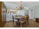 Dining room features hardwood floors and a view to the kitchen with breakfast bar seating at 1586 Gulf Blvd # 2502, Clearwater, FL 33767