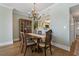 Elegant dining room features a chandelier and a view to the kitchen with breakfast bar seating at 1586 Gulf Blvd # 2502, Clearwater, FL 33767