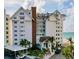 Beautiful exterior view of beachside condo building with well-maintained landscaping, covered parking and ocean view at 1586 Gulf Blvd # 2502, Clearwater, FL 33767