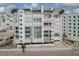 Exterior view of a beachfront building featuring multiple balconies and storm shutters for protection at 1586 Gulf Blvd # 2502, Clearwater, FL 33767