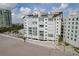 Exterior angle shot of a large beachfront building with multiple balconies overlooking the ocean at 1586 Gulf Blvd # 2502, Clearwater, FL 33767