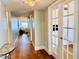 Bright hallway with hardwood floors leads to living area with ocean views, enhanced by decorative lighting and neutral paint at 1586 Gulf Blvd # 2502, Clearwater, FL 33767