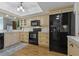 Updated kitchen with shaker cabinets, black appliances, and a breakfast bar with stylish lighting at 1586 Gulf Blvd # 2502, Clearwater, FL 33767