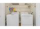 Laundry room with white washer and dryer and shelves at 1586 Gulf Blvd # 2502, Clearwater, FL 33767