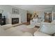 Open-concept living room featuring a fireplace, hardwood floors, and comfortable seating at 1586 Gulf Blvd # 2502, Clearwater, FL 33767