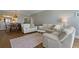Open-concept living room and dining area features hardwood floors and comfortable seating at 1586 Gulf Blvd # 2502, Clearwater, FL 33767