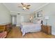 Comfortable main bedroom with ceiling fan, hardwood floors, and light green walls at 1586 Gulf Blvd # 2502, Clearwater, FL 33767