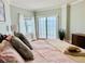 Comfortable bedroom with a king-size bed, balcony access, and ocean views at 1586 Gulf Blvd # 2502, Clearwater, FL 33767