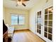 Home office with a futon, wood floors, and natural light; the room features double french doors at 1586 Gulf Blvd # 2502, Clearwater, FL 33767