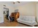 Comfortable home office with hardwood flooring, vintage-style desk, and couch with a large window at 1586 Gulf Blvd # 2502, Clearwater, FL 33767