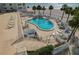 Poolside deck with lounge chairs, tables, umbrellas and views of beach at 1586 Gulf Blvd # 2502, Clearwater, FL 33767