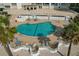 Inviting community pool with ample seating and lush landscaping at 1586 Gulf Blvd # 2502, Clearwater, FL 33767