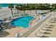 Aerial view of a sparkling pool with lounge chairs and umbrellas at a beachside condominium at 1586 Gulf Blvd # 2502, Clearwater, FL 33767