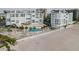 Exterior aerial view of a white fenced in pool at a beachfront building at 1586 Gulf Blvd # 2502, Clearwater, FL 33767