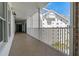Exterior walkway with tile flooring and white railings, showcasing the building's facade at 1586 Gulf Blvd # 2502, Clearwater, FL 33767