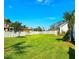 Expansive, well-maintained backyard features a lush lawn and secure white picket fence, perfect for outdoor enjoyment at 1608 20Th W Ave, Palmetto, FL 34221