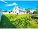 Spacious backyard featuring lush green lawn, a trampoline, and white vinyl fencing at 1608 20Th W Ave, Palmetto, FL 34221