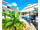 Beautiful backyard with pool, spa, lush landscaping, and covered patio with outdoor kitchen at 1608 20Th W Ave, Palmetto, FL 34221