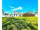 Expansive backyard with vibrant green grass, a trampoline, and a modern privacy fence at 1608 20Th W Ave, Palmetto, FL 34221