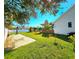 Landscaped backyard features mature trees, paver area, and privacy fence, providing a serene outdoor setting at 1608 20Th W Ave, Palmetto, FL 34221