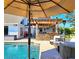 Backyard featuring a pool, outdoor kitchen, patio, and comfortable seating at 1608 20Th W Ave, Palmetto, FL 34221