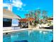 Backyard featuring a pool, outdoor kitchen, patio, and well-maintained landscaping at 1608 20Th W Ave, Palmetto, FL 34221