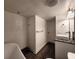 Bathroom with a soaking tub, modern vanity, and stylish textured tile walls at 1608 20Th W Ave, Palmetto, FL 34221