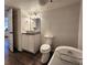 Bathroom featuring a sleek vanity, modern toilet, and a luxurious soaking tub at 1608 20Th W Ave, Palmetto, FL 34221