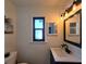 Bathroom features a mosaic tiled shower, toilet, and vanity with black hardware at 1608 20Th W Ave, Palmetto, FL 34221