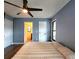 Bedroom features a modern ceiling fan, wood floors, and light blue walls at 1608 20Th W Ave, Palmetto, FL 34221