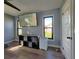 Bedroom with light blue walls, modern ceiling fan, wood look flooring, and outdoor views at 1608 20Th W Ave, Palmetto, FL 34221