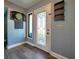 Well-lit entryway featuring a stylish door, dart board, and wood flooring at 1608 20Th W Ave, Palmetto, FL 34221