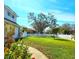 Well-manicured front yard with white picket fence, lush lawn, and mature trees at 1608 20Th W Ave, Palmetto, FL 34221