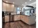 Updated kitchen with granite countertops, stainless steel appliances, and wood-look flooring at 1608 20Th W Ave, Palmetto, FL 34221