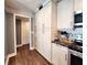 Kitchen with hardwood floors, stainless steel appliances, and plentiful storage space in white cabinets at 1608 20Th W Ave, Palmetto, FL 34221